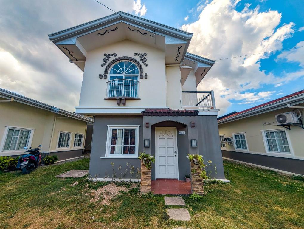 a large white house with a white door at Panglao 4 Bedroom Family and Group House With Pool in Dauis