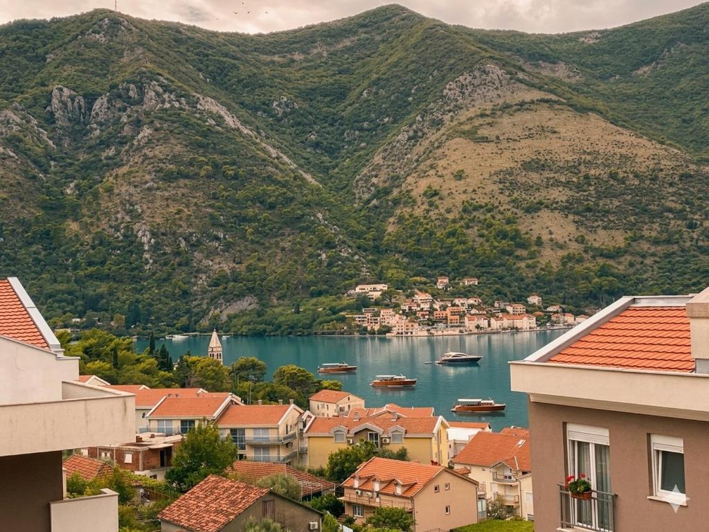 a view of a town with boats in the water at Belvedere in Dobrota