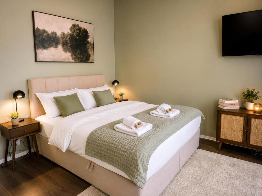 a bedroom with a bed with two towels on it at Schängel Chic 2 in Koblenz