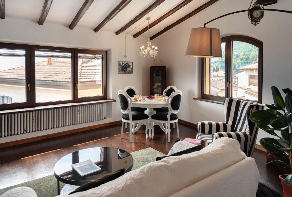 a living room with a table and chairs at Vista Menaggio Centro by LoveComo in Menaggio