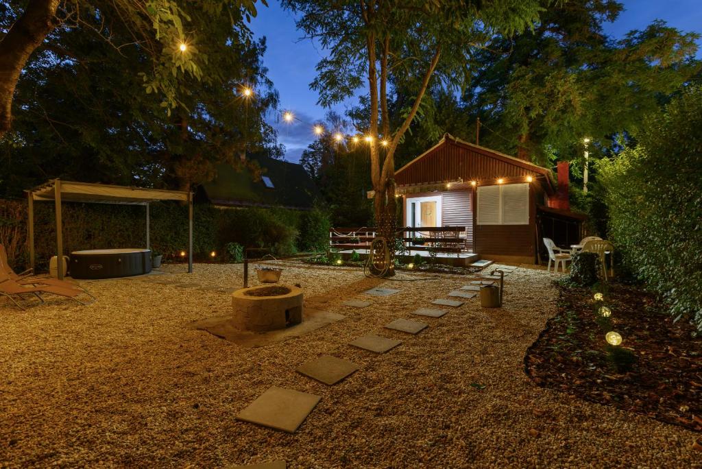 a backyard with a fire pit and a building at Csendliget Apartman in Dunavarsány