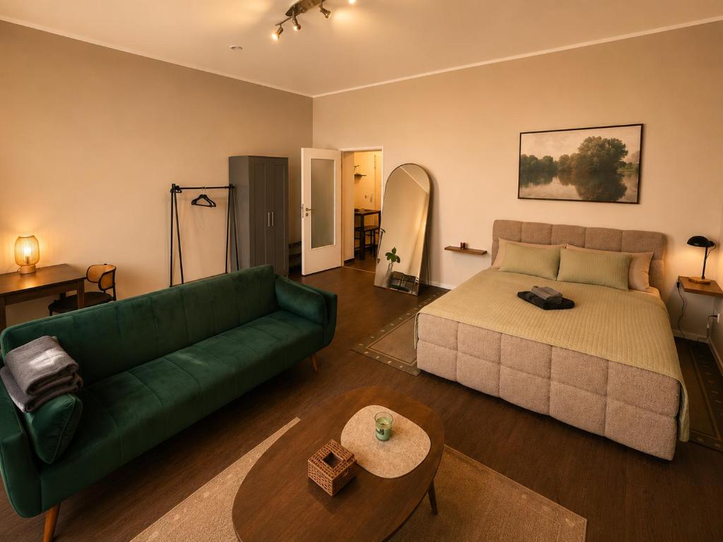a living room with a green couch and a table at Schängel Chic 03 in Koblenz