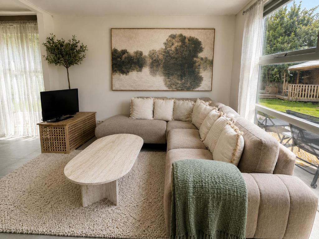 a living room with a couch and a coffee table at Ecolodges De Dreef Guesthouse in Renesse
