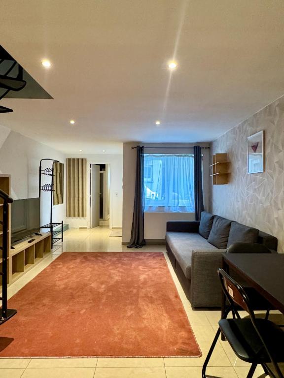 a living room with a couch and a rug at Yamohome in Brussels