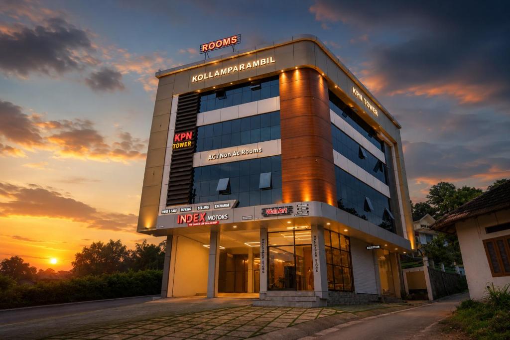a building with a sunset in front of it at KPN Tower in Erāttupetta