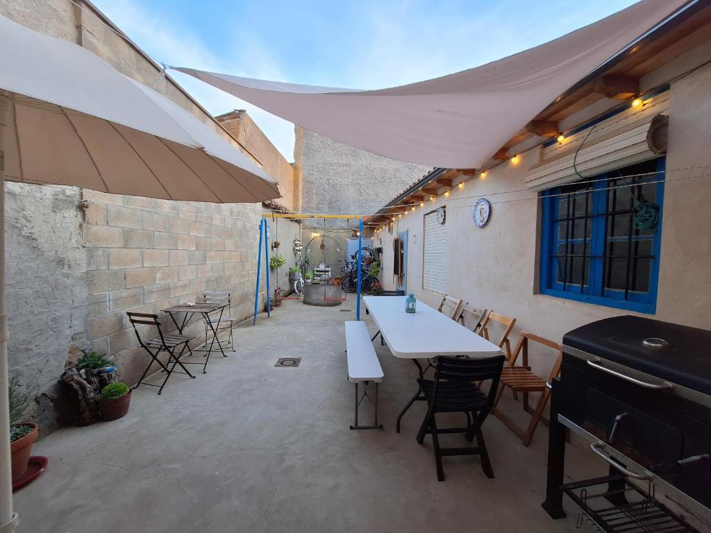 a patio with tables and chairs in a building at CASA PITA Completa Grupos in San Justo de la Vega