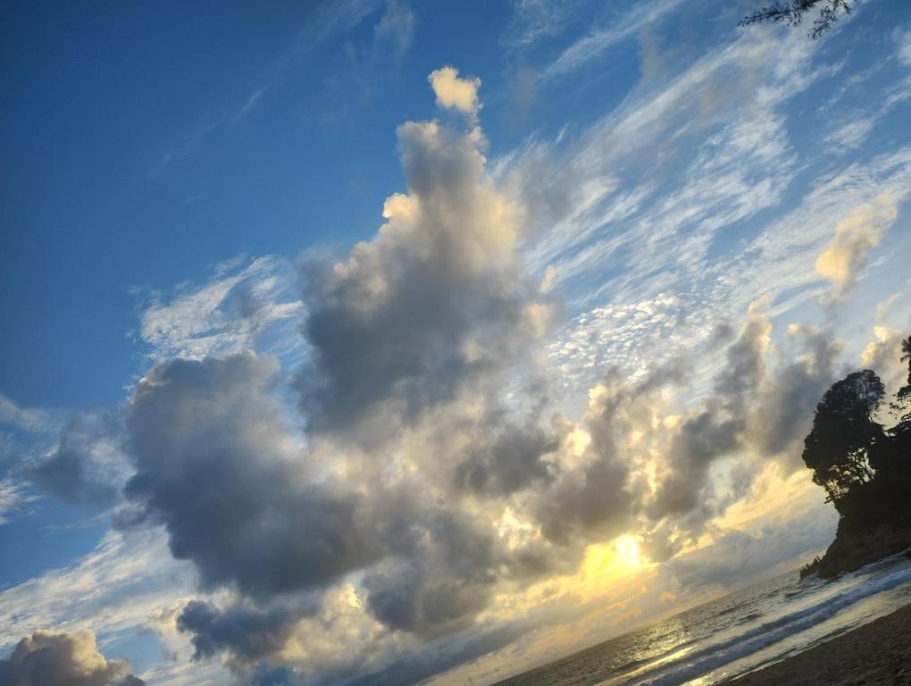 a large cloud formation in the sky over the ocean at enDanni Bed in Ban Phak Chit
