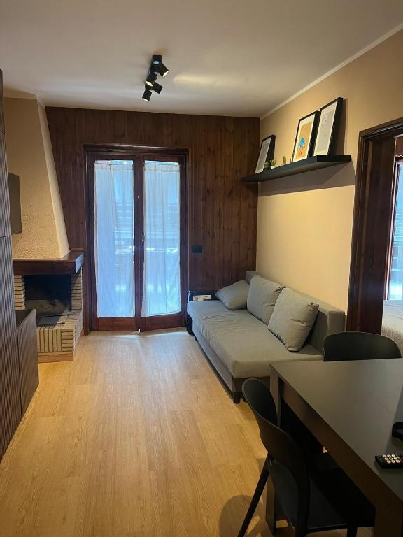 a living room with a couch and a table at FREE PARKING - Edilneve Apartment in Roccaraso