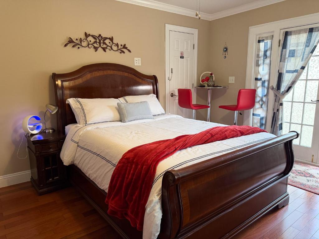a bedroom with a large bed and red chairs at National Harbor Suite 2 in Fort Washington