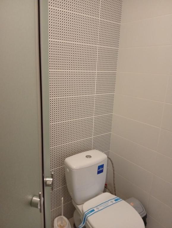 a bathroom with a white toilet in a stall at Potemkin view suites in Odesa