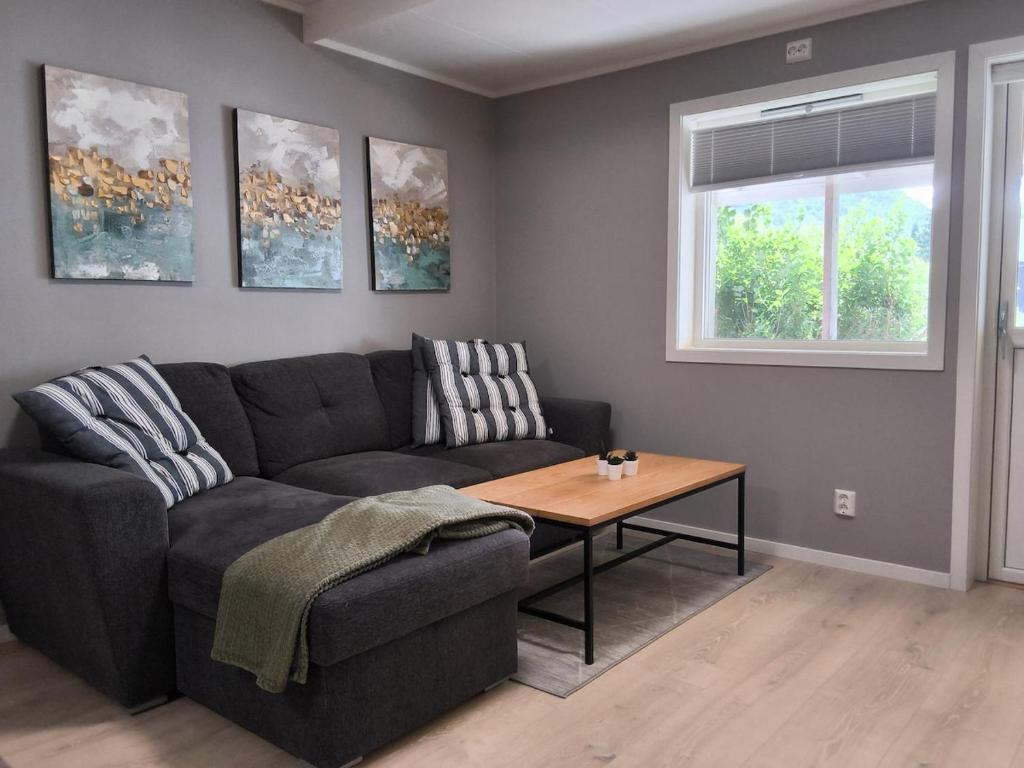 a living room with a couch and a table at Modern 1BR City Centre Apt - Sleeps 4 in Otta