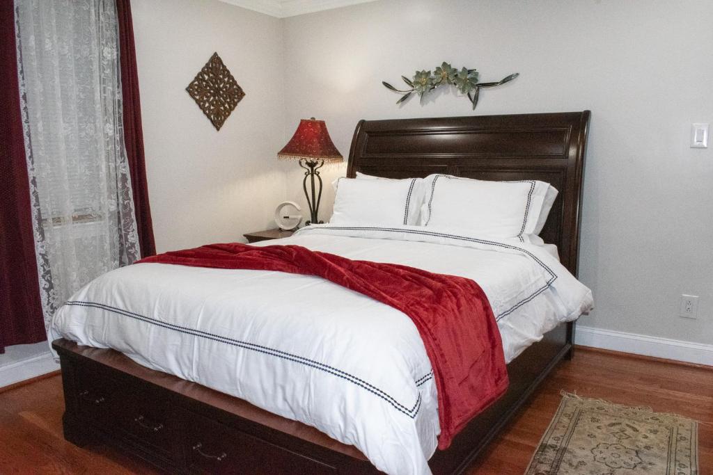 a bedroom with a large bed with a red blanket at National Harbor Suite 3 in Fort Washington