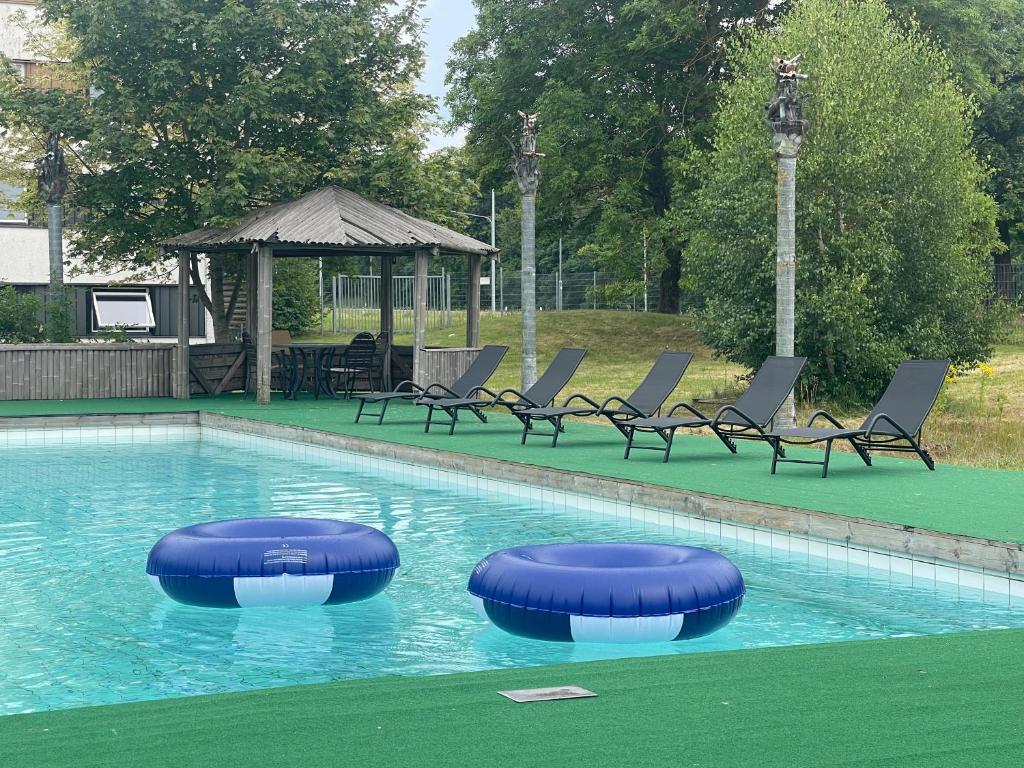 a swimming pool with two blue rings in the water at First Hotel Halmstad East in Halmstad