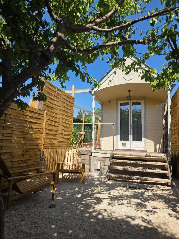 a house with a bench in front of it at Ailéa Tiny House avec jacuzzi privatif in Beaumes-de-Venise