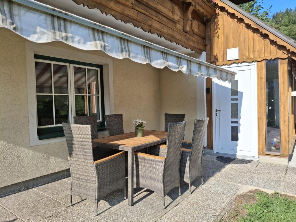 a wooden table and chairs on a patio at Ferienwohnung Edith-Maria in Bad Goisern