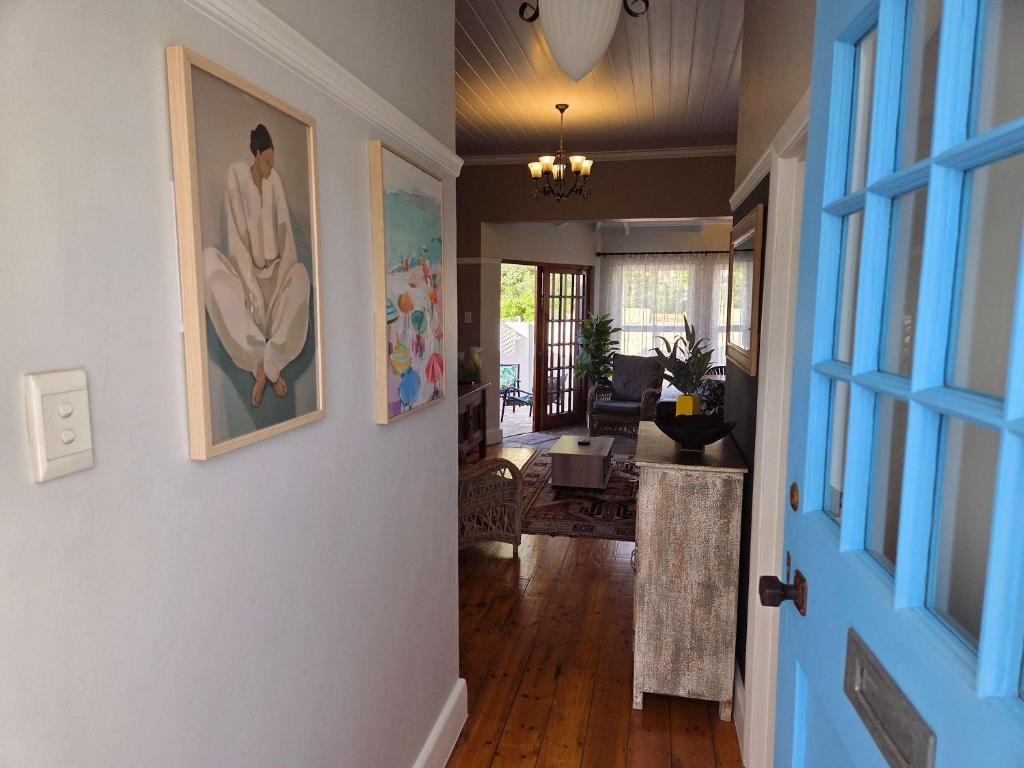 a hallway of a home with a painting on the wall at Beach Street Self-Catering in Mossel Bay