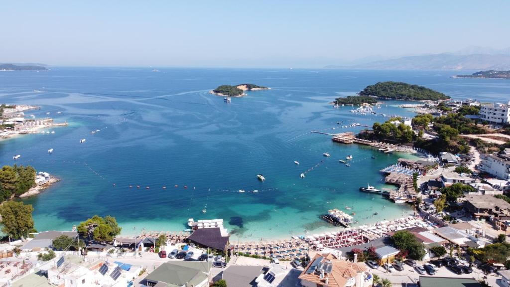 an aerial view of a harbor with boats in the water at Rooftop panoramic jacuzzi room in Ksamil