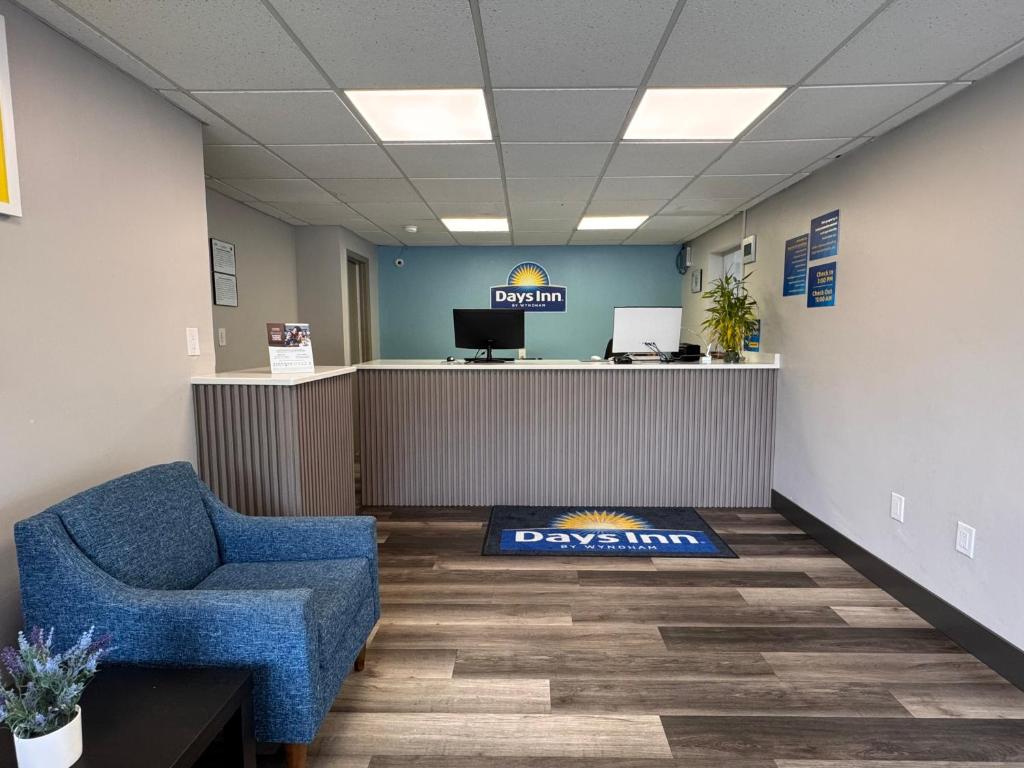 an office with a waiting room with a chair and a desk at Days Inn by Wyndham Gainesville Hospital - University Area in Gainesville
