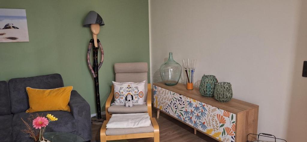 a living room with a couch and a chair at Ferienwohnung in der Nähe vom Möhnesee-Arnsberg-Breitenbruch in Arnsberg