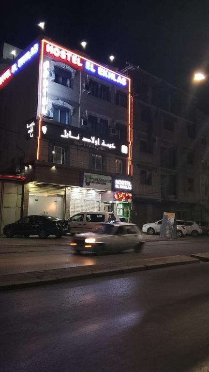 a car driving past a building at night at مرقد الاخلاص in Fort de lʼEau
