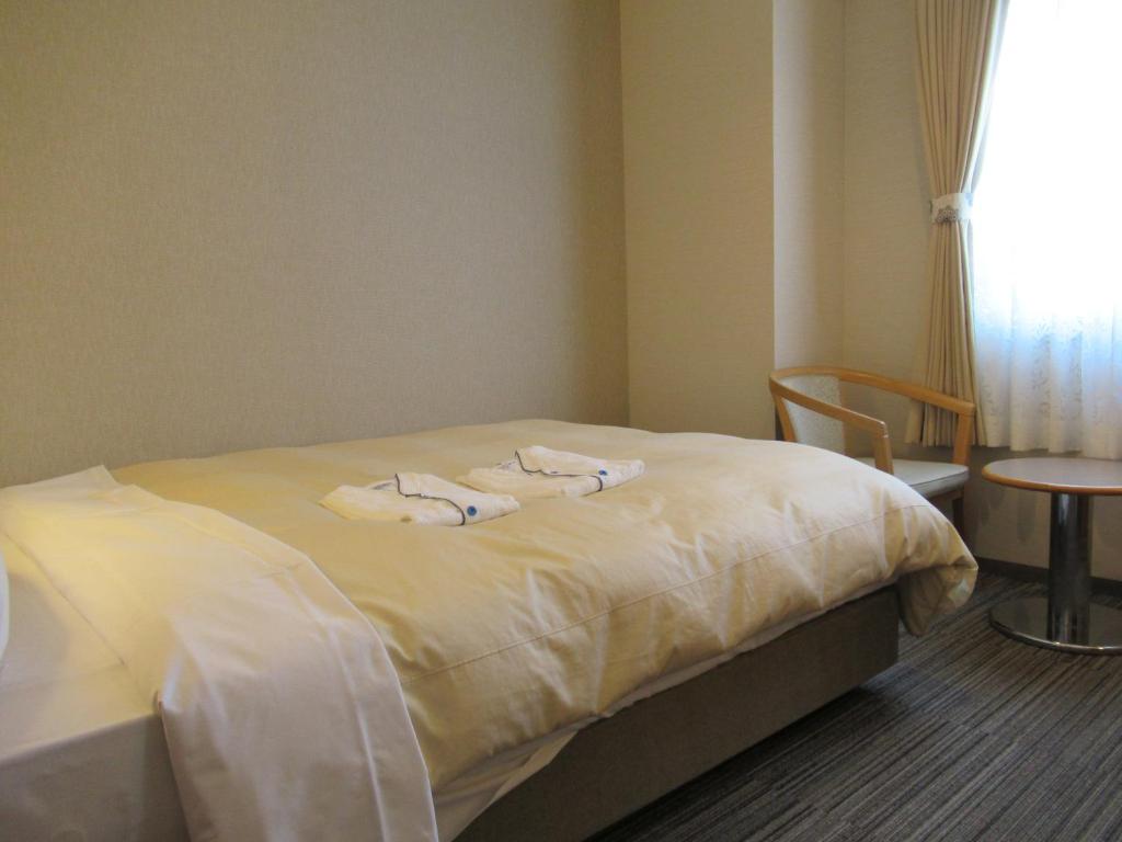 Postel nebo postele na pokoji v ubytování Center Hotel Mihara