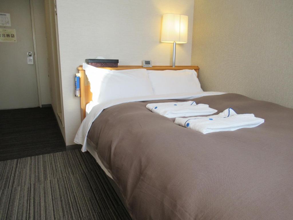 Postel nebo postele na pokoji v ubytování Center Hotel Mihara