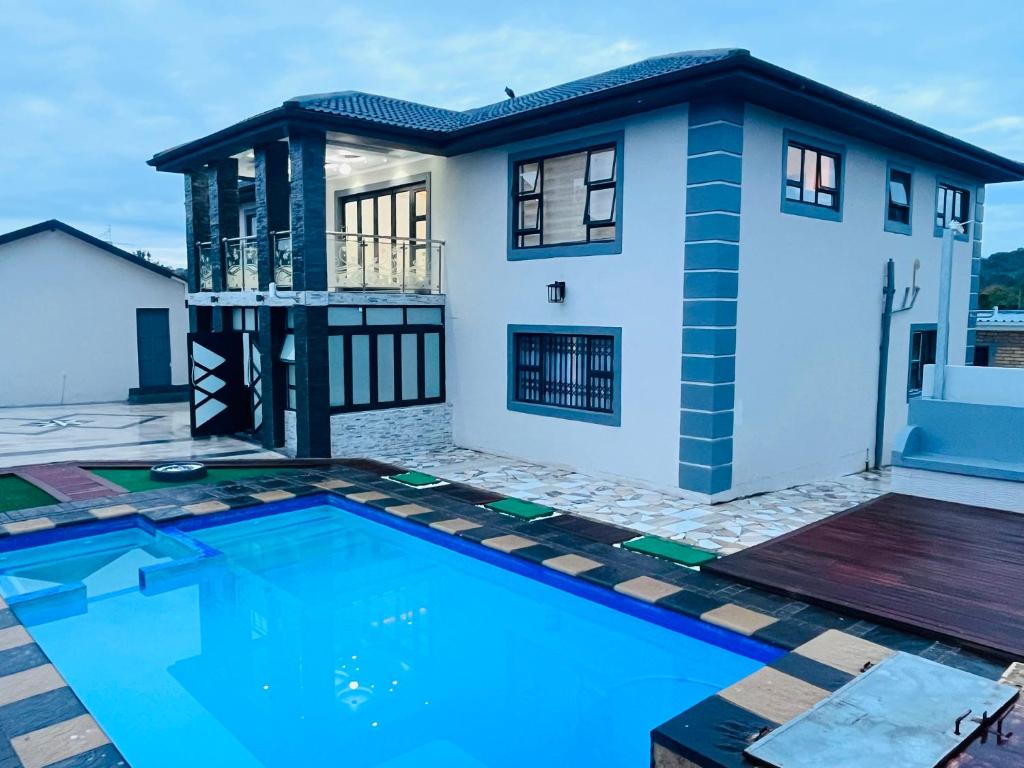 a house with a swimming pool in front of it at Kumnandi Modern Suite in Beacon Bay