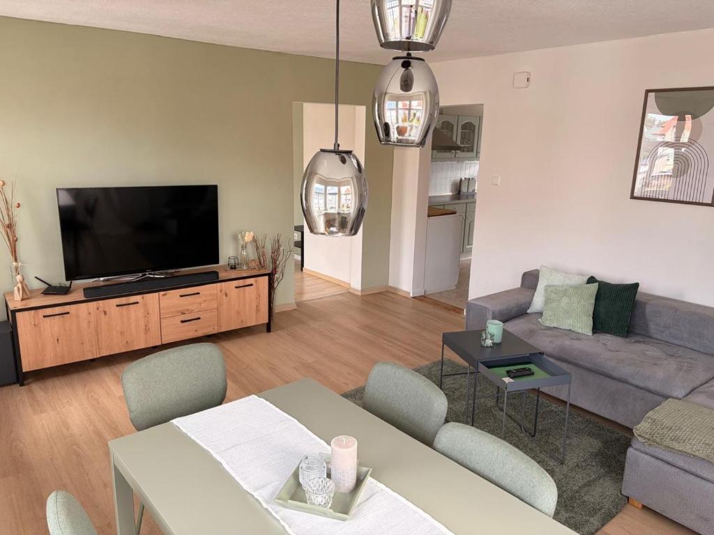 a living room with a couch and a flat screen tv at StadtQuartier Gardelegen in Gardelegen