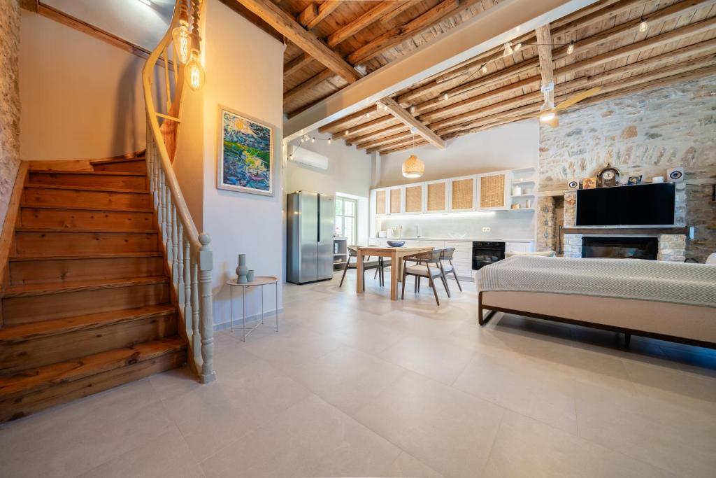 a bedroom with a bed and a dining room at Meraki Villa Pelion in Kalamos