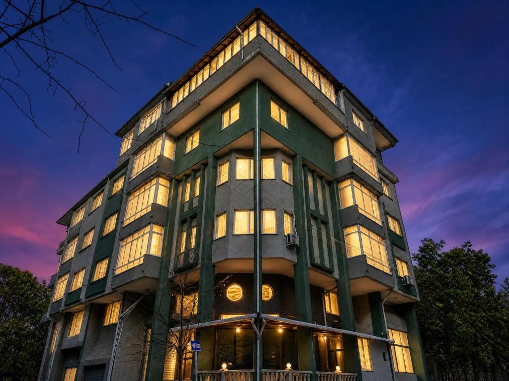 a tall building with many windows at dusk at Corner Park Suites City Center Corlu in Çorlu