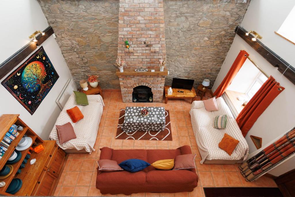 an overhead view of a living room with a couch and a fireplace at The Barn at Bar Hall Bay in Portaferry