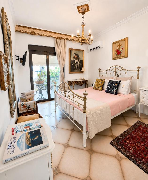 a bedroom with a bed in a room with a window at Popis Maison in Rhodes Town