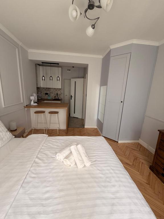 a bedroom with a white bed with two towels on it at Apartament centrum in Białystok
