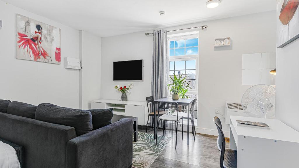 a living room with a couch and a table at Birmingham Central Luxury Suites in Birmingham