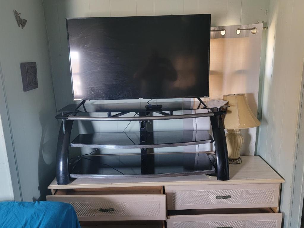 a tv sitting on top of a dresser at ARMANI MANOR UPSTAIRS UNIT 3 quaint rustic 1br in Wildwood