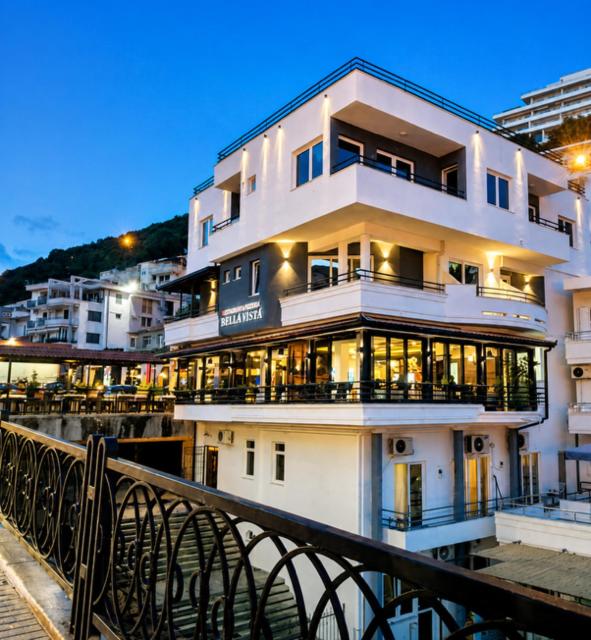 a large white building next to a body of water at Bella Vista B&B in Ulcinj