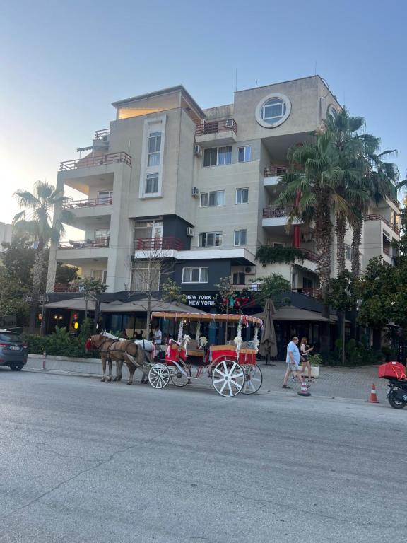 a horse drawn carriage in front of a building at HOTEL Apartments ARDO in Golem