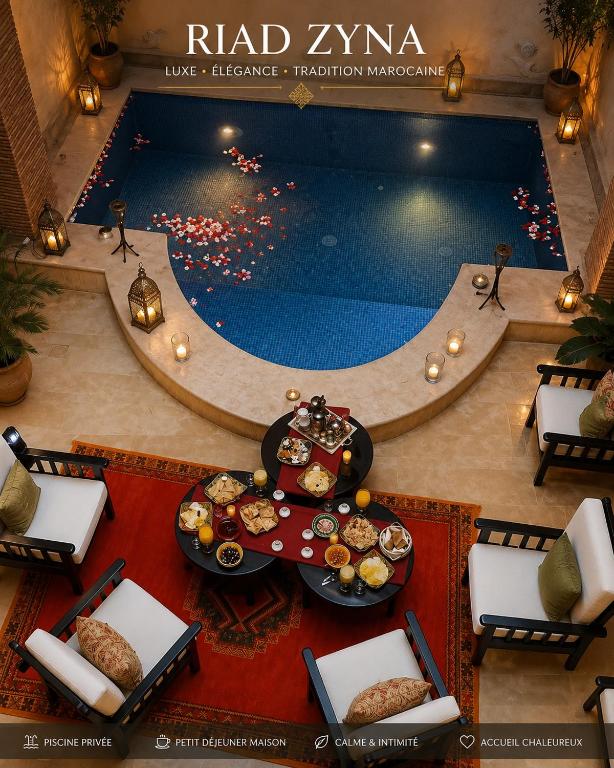 an overhead view of a swimming pool with a table with food at Riad Zyna in Meknès