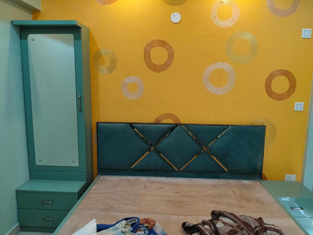 a bedroom with a bed and a wall with a mirror at North Grande in kolkata