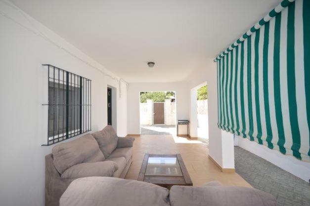 a living room with a couch and a staircase at Alba Solis in Vejer de la Frontera