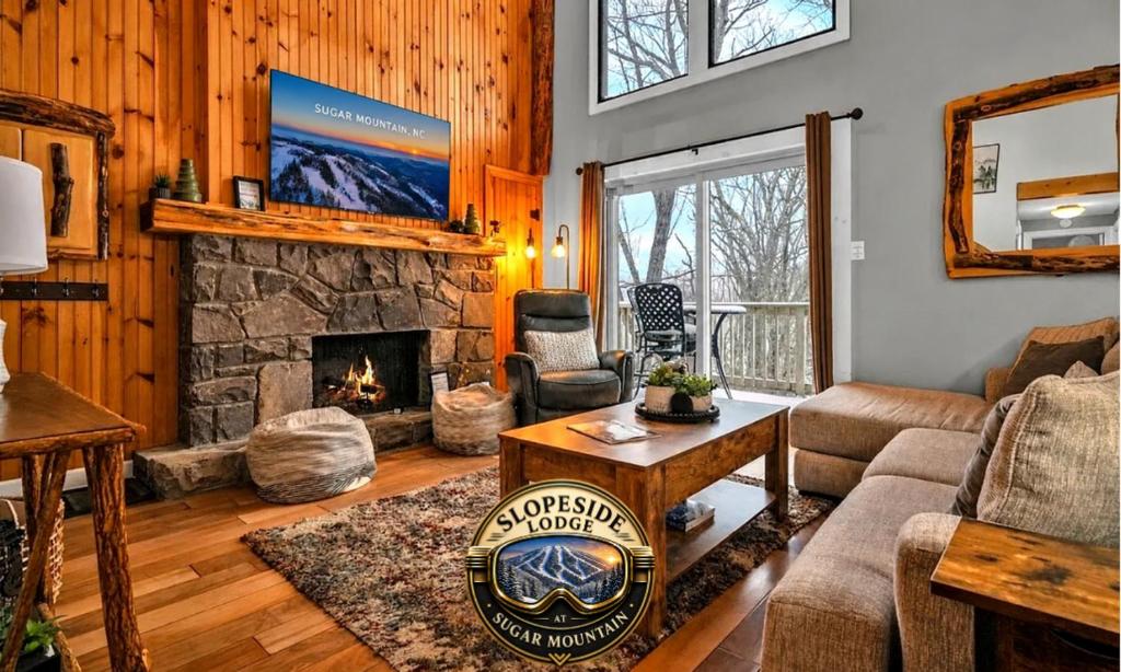 a living room with a couch and a fireplace at Slopeside Lodge at Sugar Mountain in Sugar Mountain