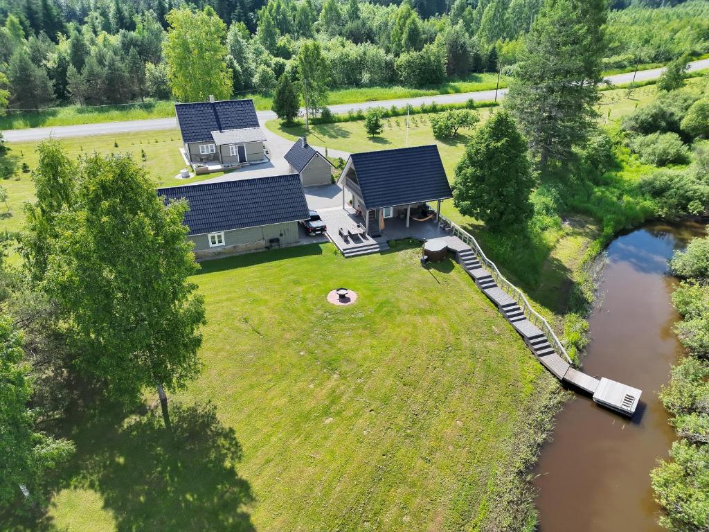 an aerial view of a house with a train on the grass at Jõesuu saunamaja in Valga