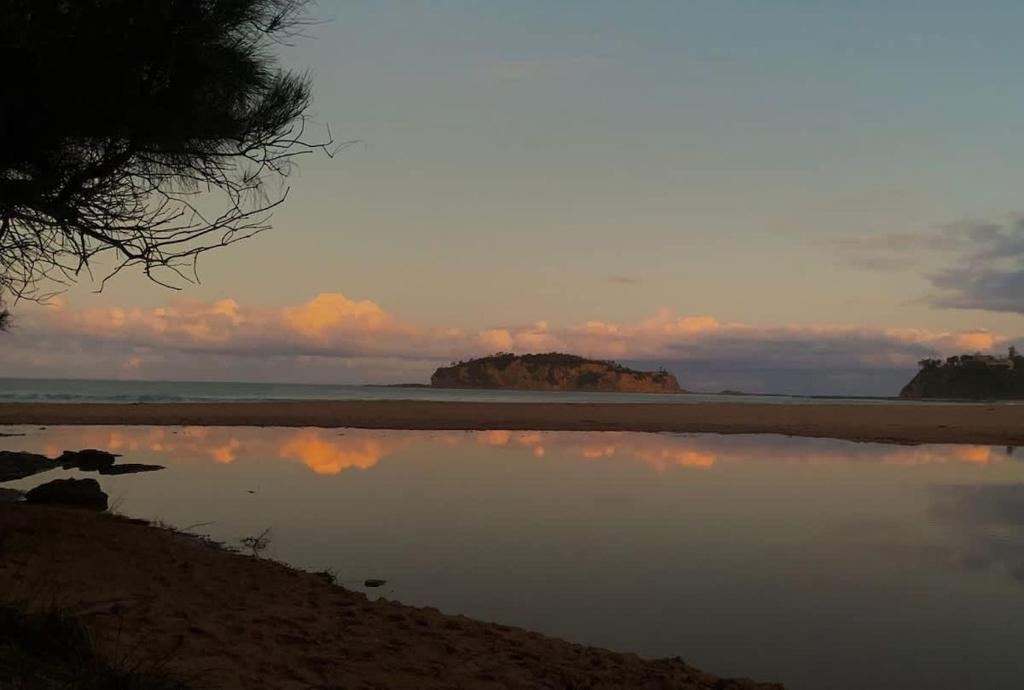 a reflection of the sky in the water on the beach at Seascapes at Rosedale in Tomakin