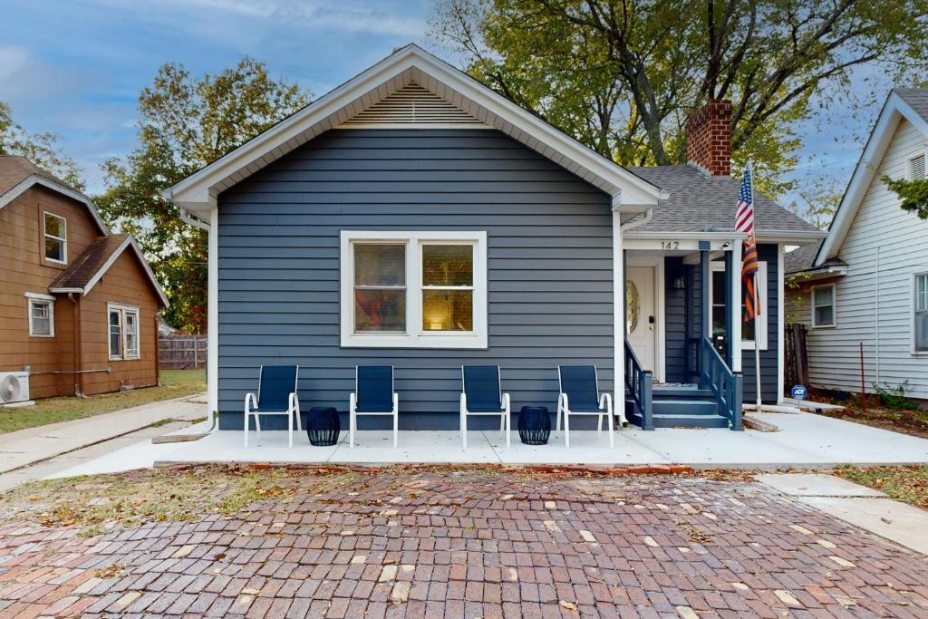 a blue house with chairs in front of it at Easy Access to OSU! 'Marvin's Manor' in Stillwater in Stillwater