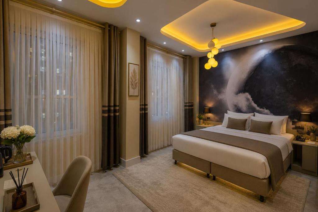 a bedroom with a king sized bed and a desk at Lidar Hotel Business Class in Urfa