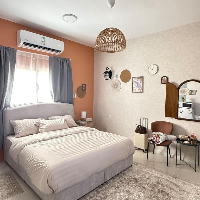 a bedroom with a large bed and a window at The Italian Studio7 in Dammam