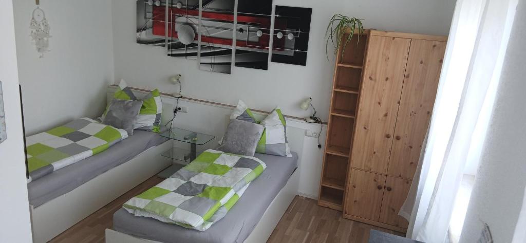 a small room with two beds and a cabinet at Zimmer zum Viadukt in Neulengbach