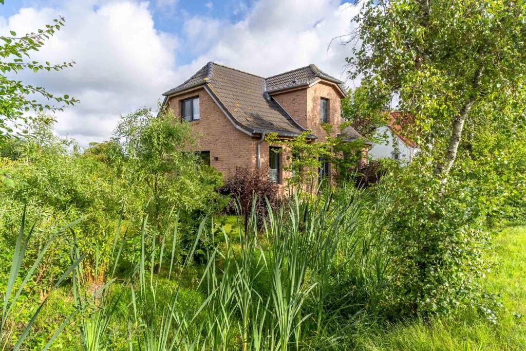 an old brick house in the middle of a field at Püppi Hems Huus in Osterhever