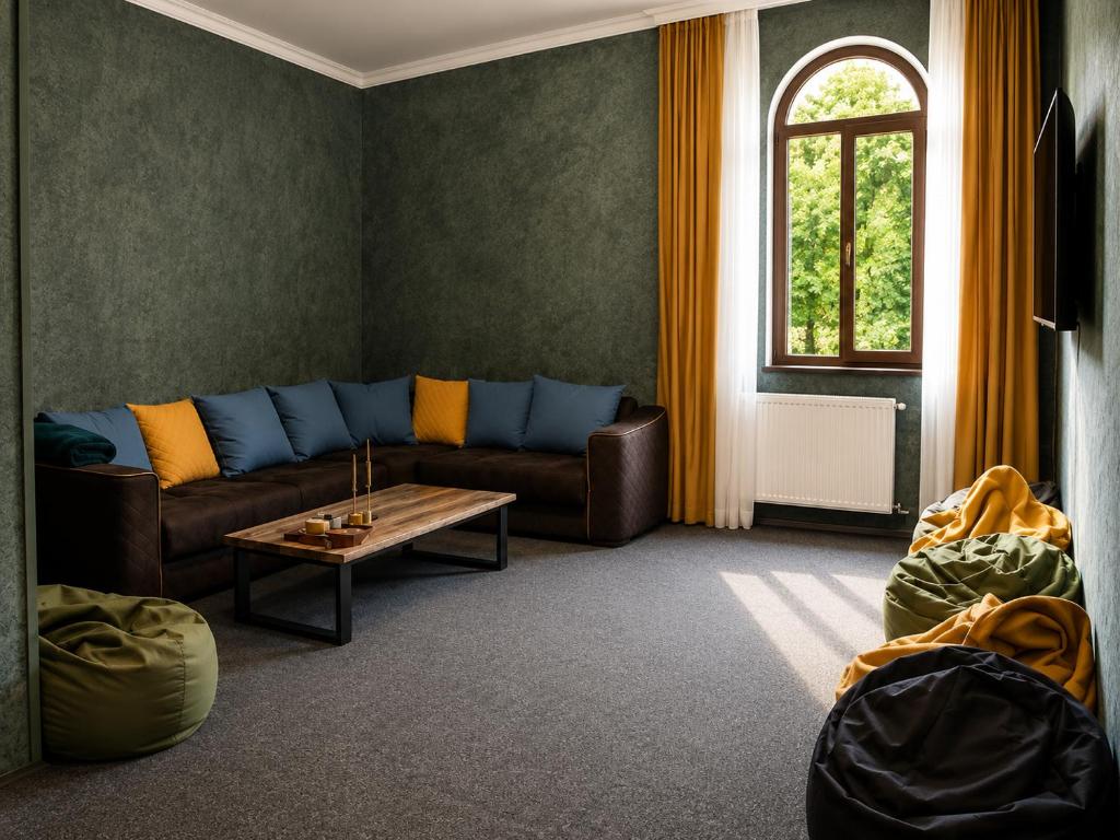 a living room with a couch and a table at Hotel Eden Mestia in Mestia