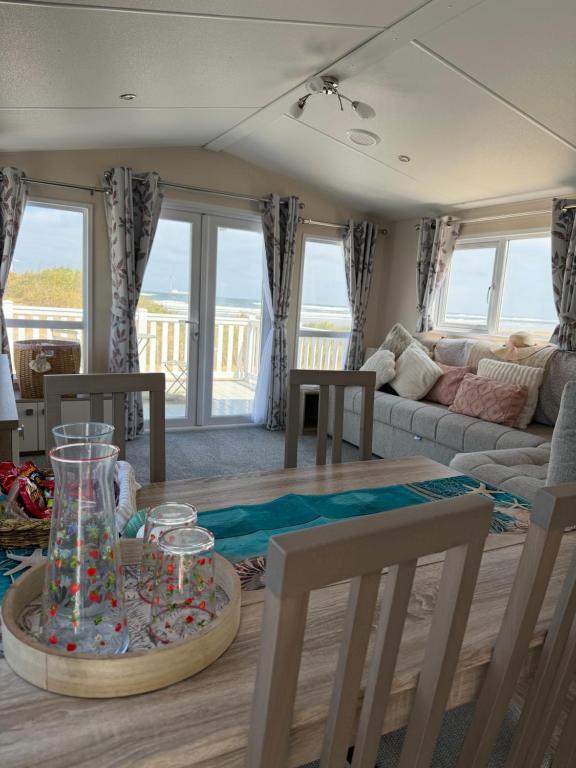 a living room with a table and a couch at Teal - a few steps from the beach in Redcar